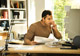 Man on Phone Using Computer