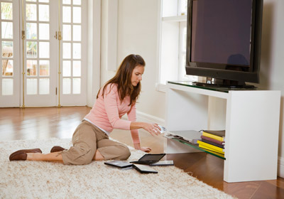 Woman Placing Disc in DVD Player