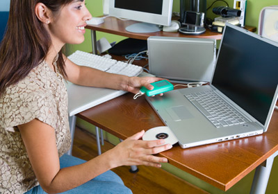 Woman With Laptop CD and MP3 Device