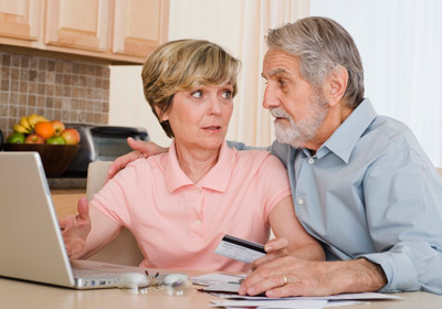 Elderly Couple With Bills and Laptop Elderly Couple With Bills and Laptop
