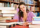 Woman Studying Near Stack of Books