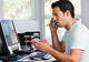 man on phone at a computer