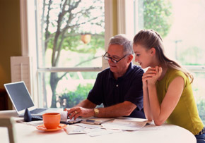 Father and Daughter With Laptop and Paperwork Father and Daughter With Laptop and Paperwork