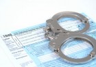Handcuffs on a Tax Return Form Handcuffs on a Tax Return Form