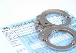 Handcuffs on a Tax Return Form Handcuffs on a Tax Return Form