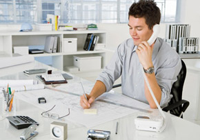 Man at Desk on the Phone Man at Desk on the Phone