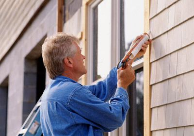 Man Caulking Window Man Caulking Window