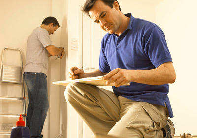 Man Inspecting Home Construction