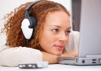 Woman With Headphones on Computer Woman With Headphones on Computer