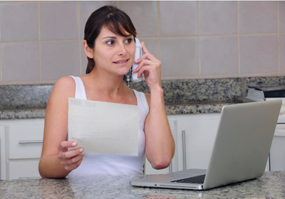 Woman on Phone With Laptop