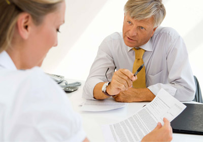 Man Explaining Document to Woman