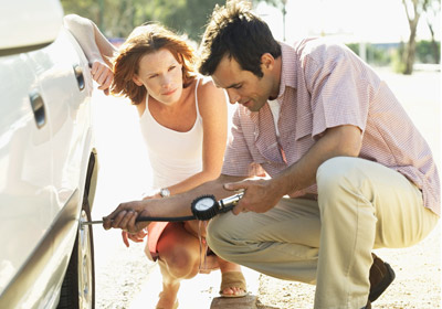 Man Checking Tire Pressure Man Checking Tire Pressure