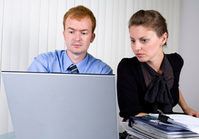 Couple With Laptop and Paperwork