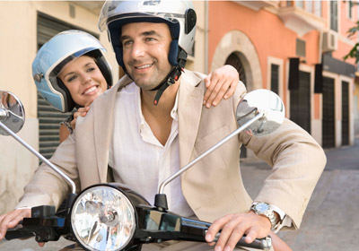 Couple Riding on a Scooter Couple Riding on a Scooter