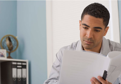 Man Looking at Documents Man Looking at Documents