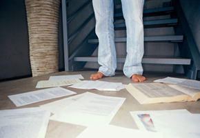 Barefoot Man With Papers and Phone Directory