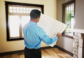 Man Inspecting Home Plans