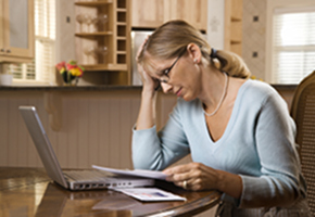 Woman With Bills and Computer