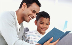 Man teaching son to read.